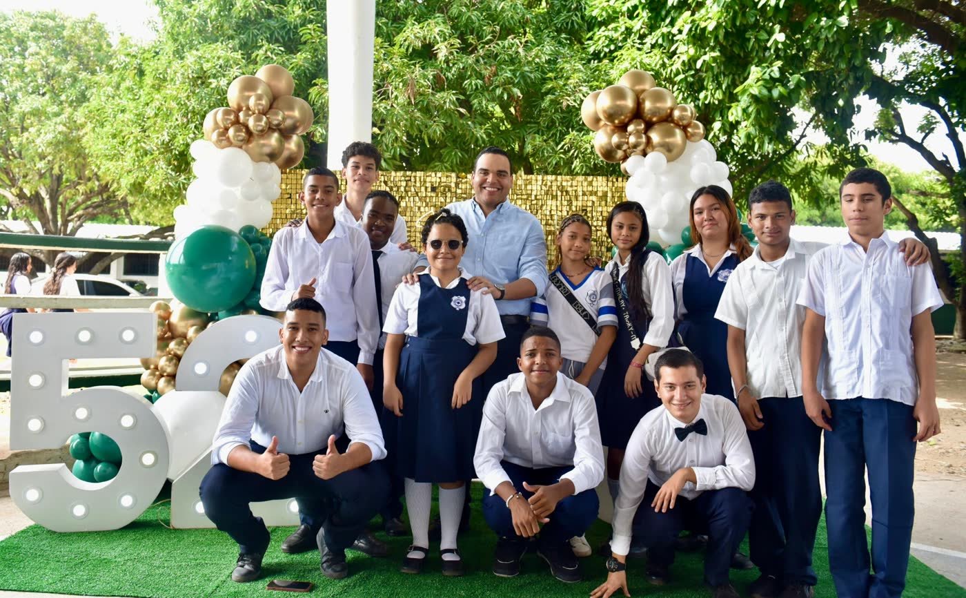 Un docente con un grupo de estudiantes en la celebración de los 52 años